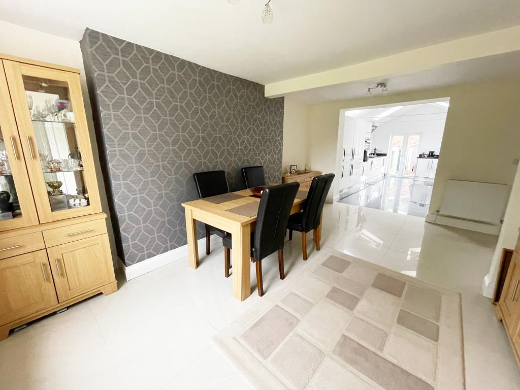 Lot: 57 - THREE-BEDROOM TERRACE HOUSE FOR REPAIR IN POPULAR ESSEX VILLAGE - Dining room on the opening to kitchen